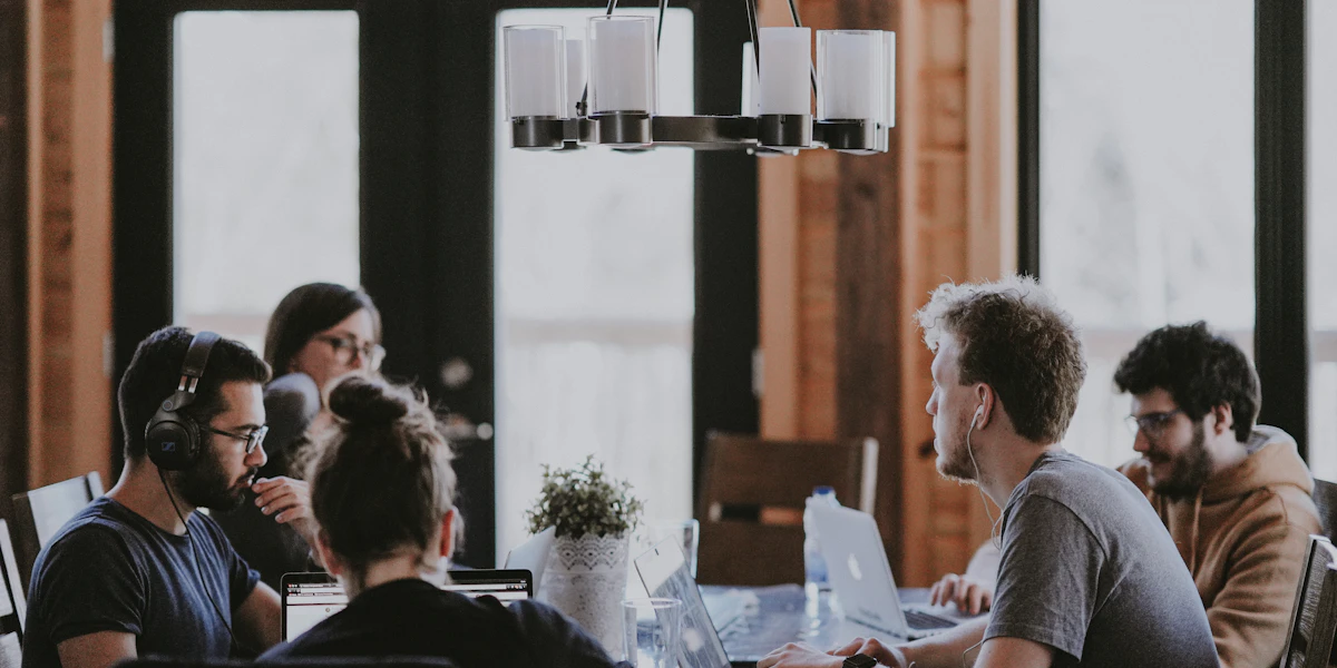 A diverse group of people collaborating around a table, representing community support for a fundraising campaign