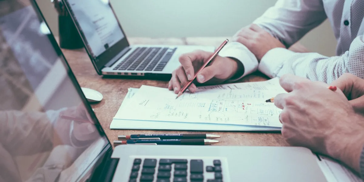 Person reviewing strategy documents and charts at a desk, planning next steps